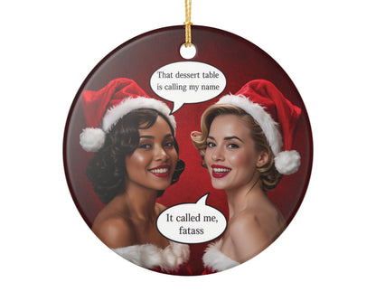 Round Christmas ornament with two women in Santa hats and humorous text bubbles on a red background.