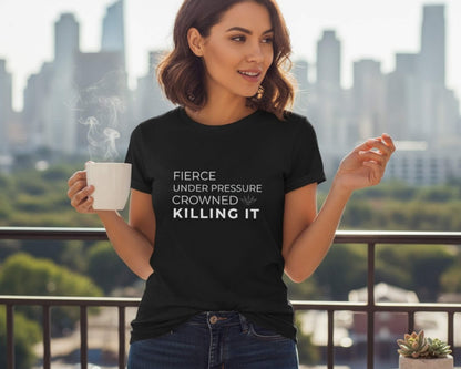Woman wearing a black t-shirt with text, holding a mug, with a cityscape in the background