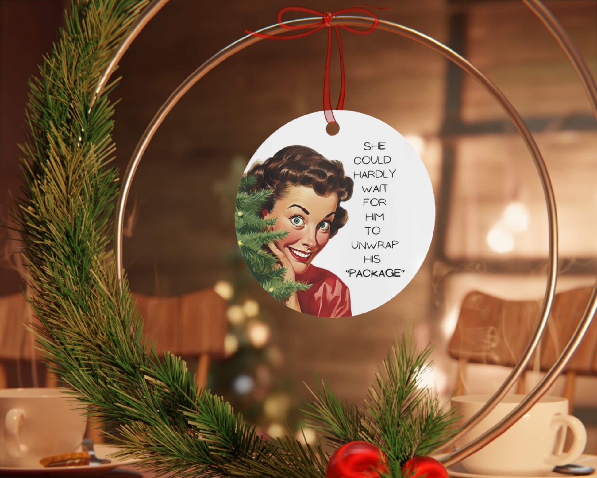 Decorative Christmas ornament with a vintage-style illustration and text, hanging on a wreath.
