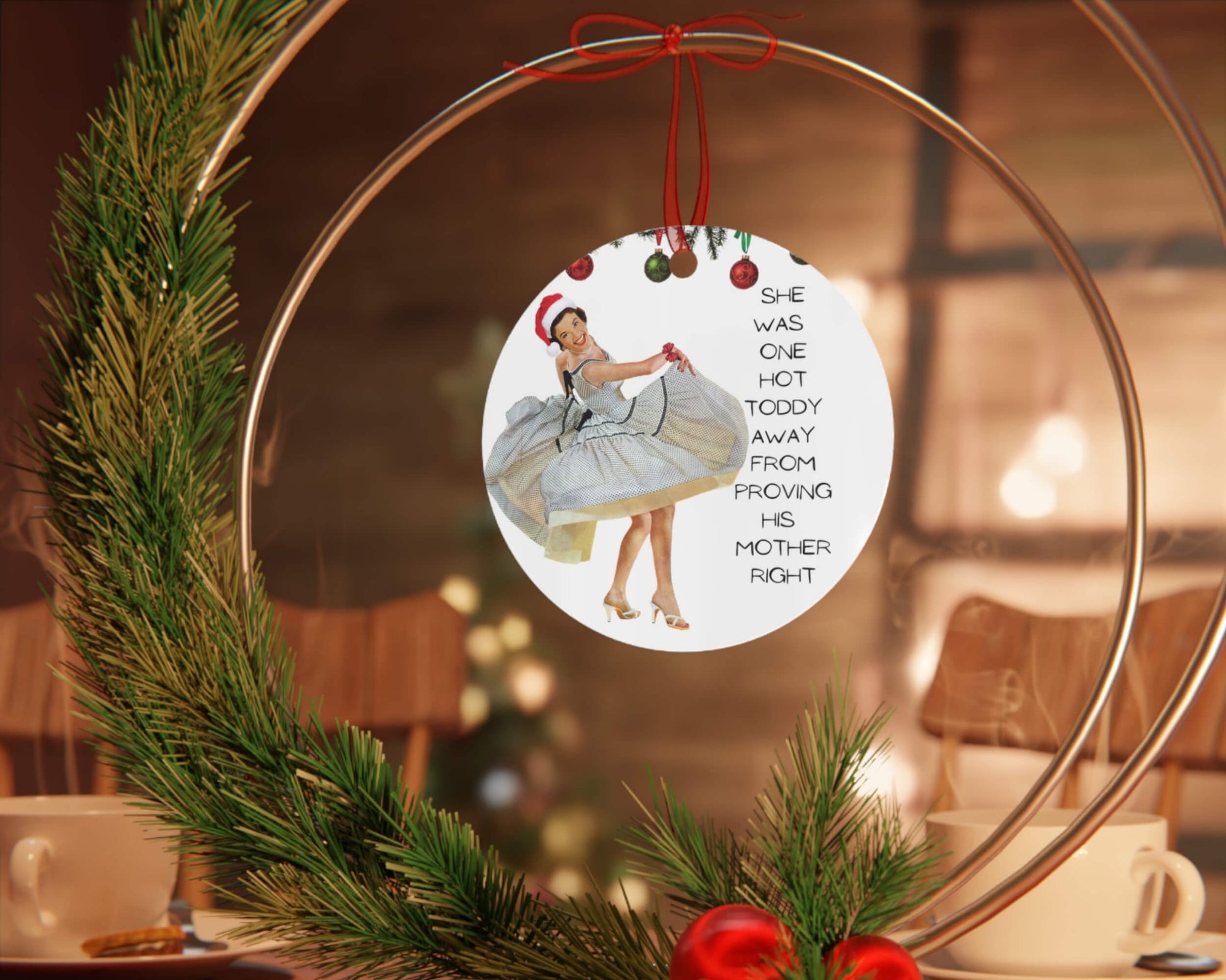 Decorative Christmas ornament with a humorous quote and image, hanging on a wreath.