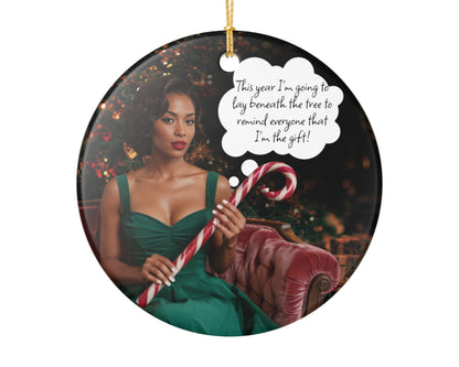 Round Christmas ornament with a woman in a green dress holding candy canes and a speech bubble with text.