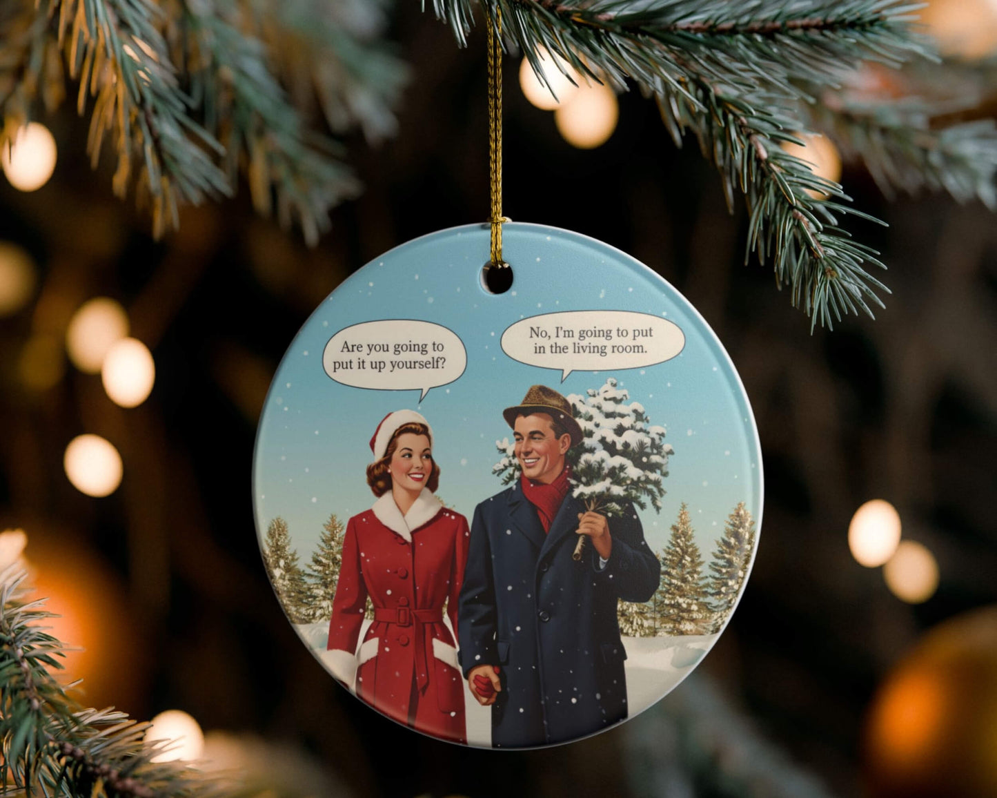 Christmas ornament with a couple and joke speech bubbles hanging on a tree.