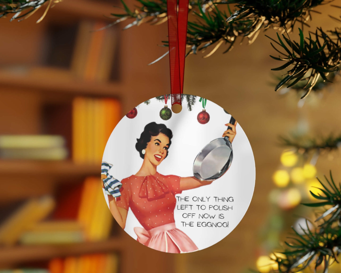 Christmas ornament with vintage-style illustration of a woman holding a spoon, hanging on a tree.