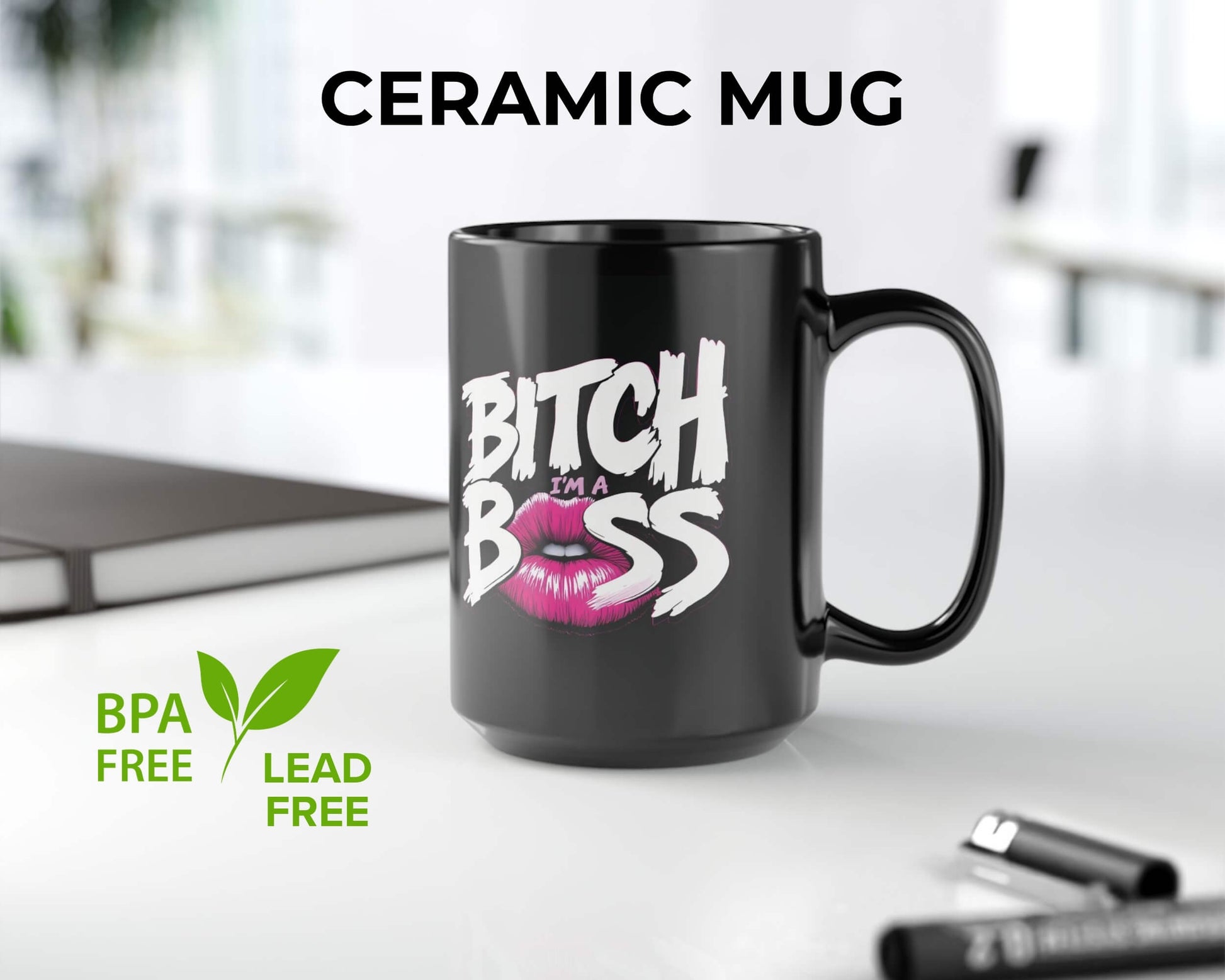 Black ceramic mug with 'Bitch I'm a Boss' text and pink lips graphic on a white surface.