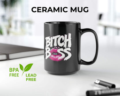 Black ceramic mug with 'Bitch I'm a Boss' text and pink lips graphic on a white surface.