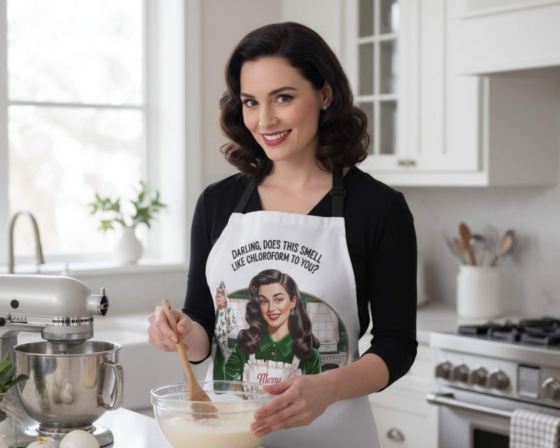 Woman in a kitchen wearing a themed apron, holding a wooden spoon.