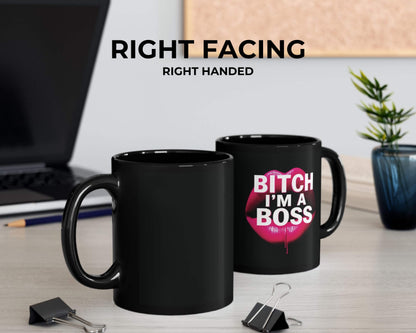 Two black mugs on a desk with one displaying 'BITCH I'M A BOSS' text.