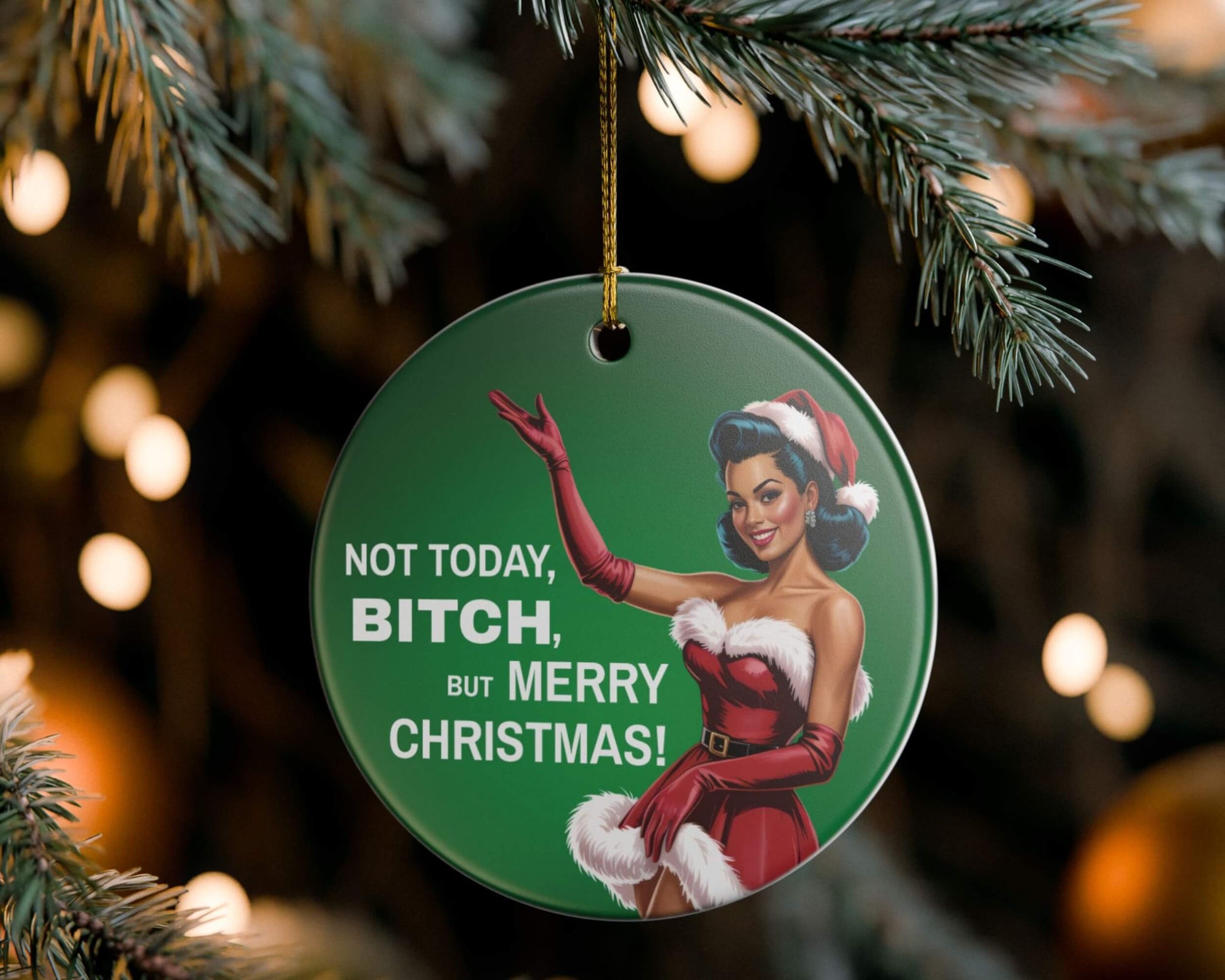 Decorative Christmas ornament with a character in a Santa outfit and humorous text, hanging on a tree.
