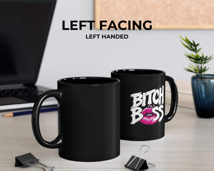 Black mug with 'Bitch Boss' text on a desk with office items.
