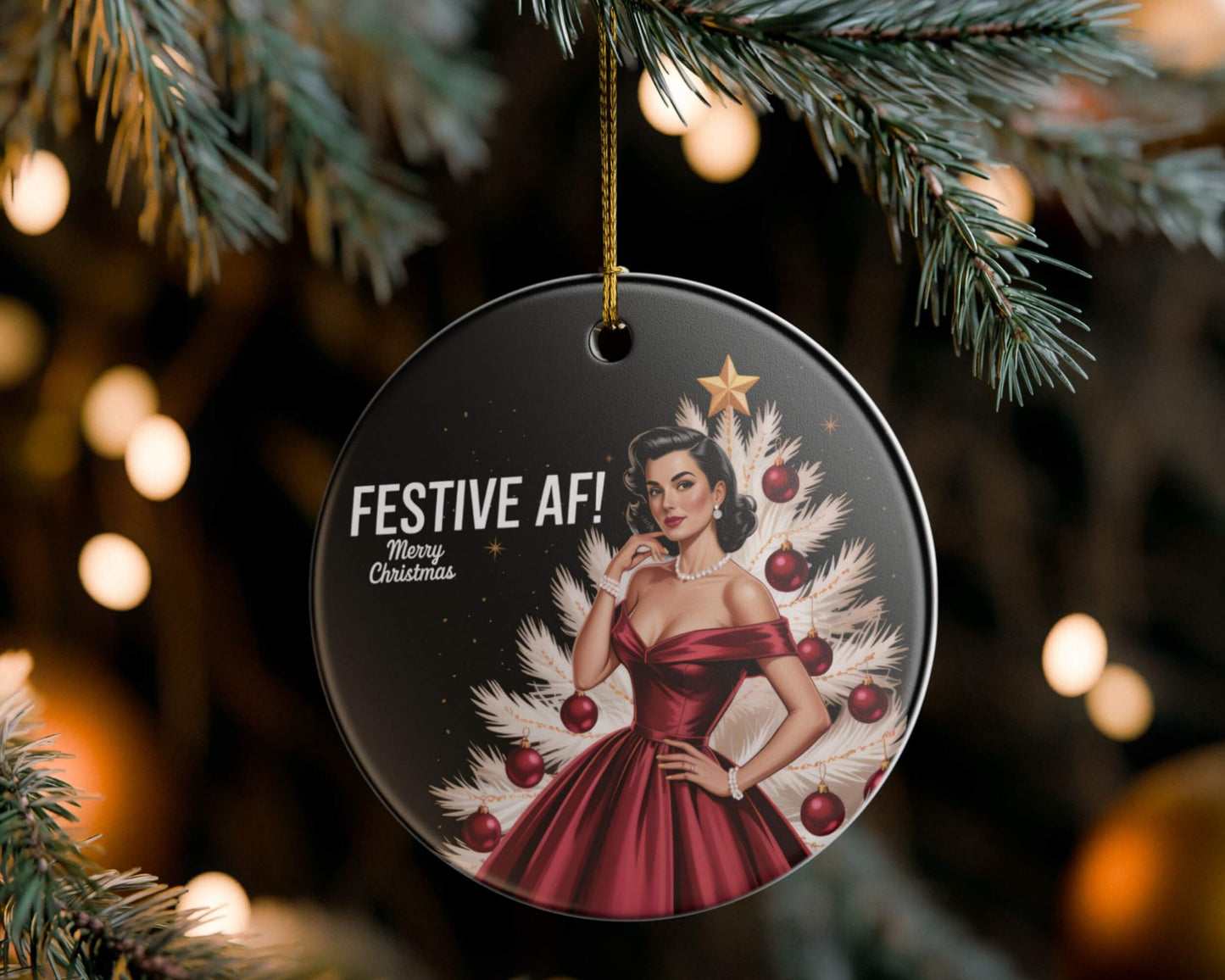 Christmas ornament with a woman in a red dress and festive tree design, hanging on a tree.