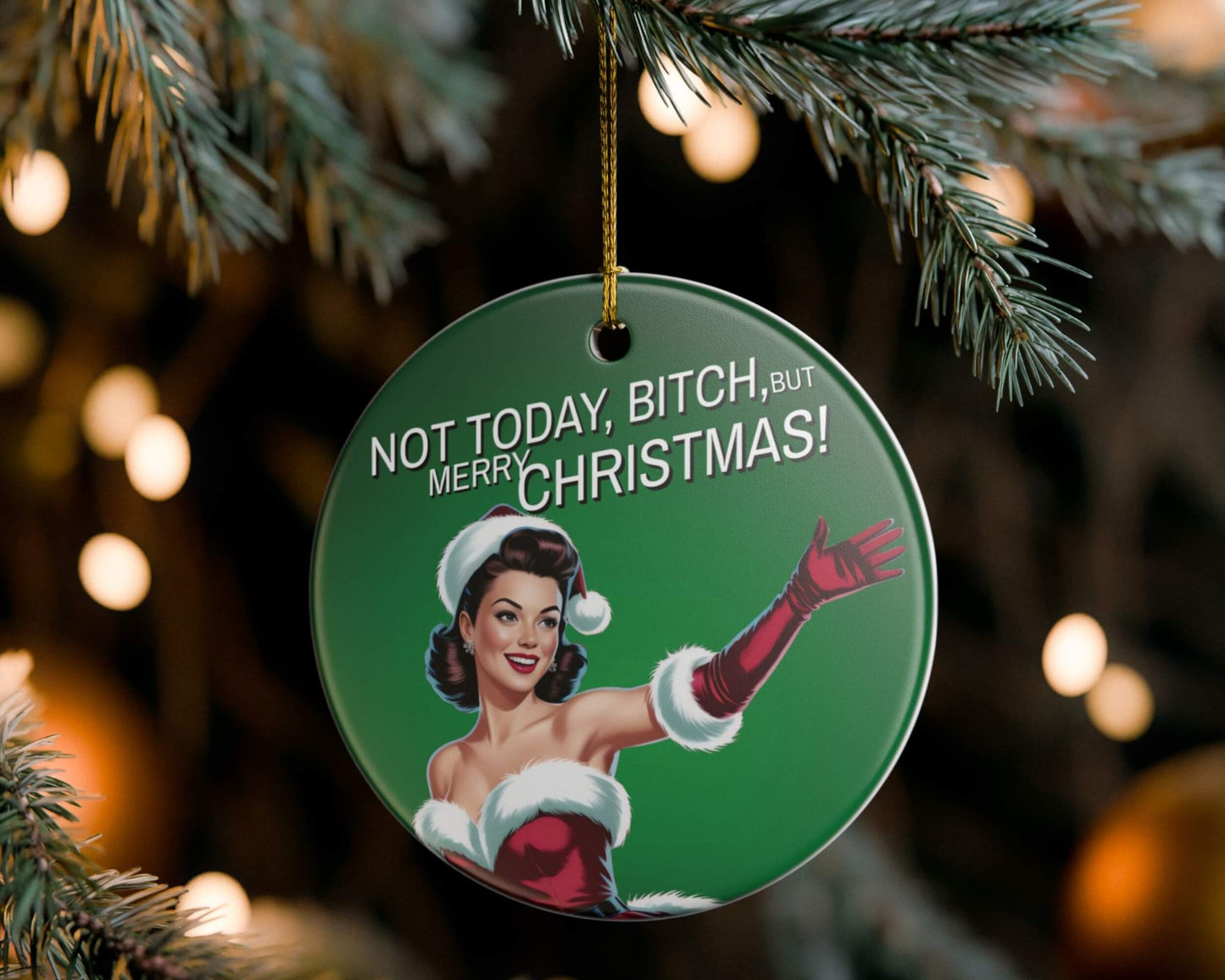 Christmas ornament with a graphic of a woman in a Santa outfit and text 'Not Today, Bitch, But Merry Christmas!' hanging on a tree.