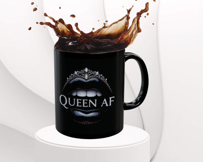 Black mug with 'Queen AF' design pouring coffee against a white background